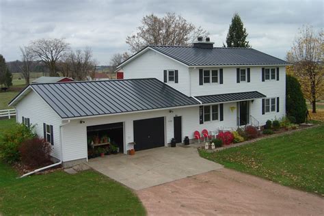 white house with charcoal gray metal roof|dark grey metal roof.